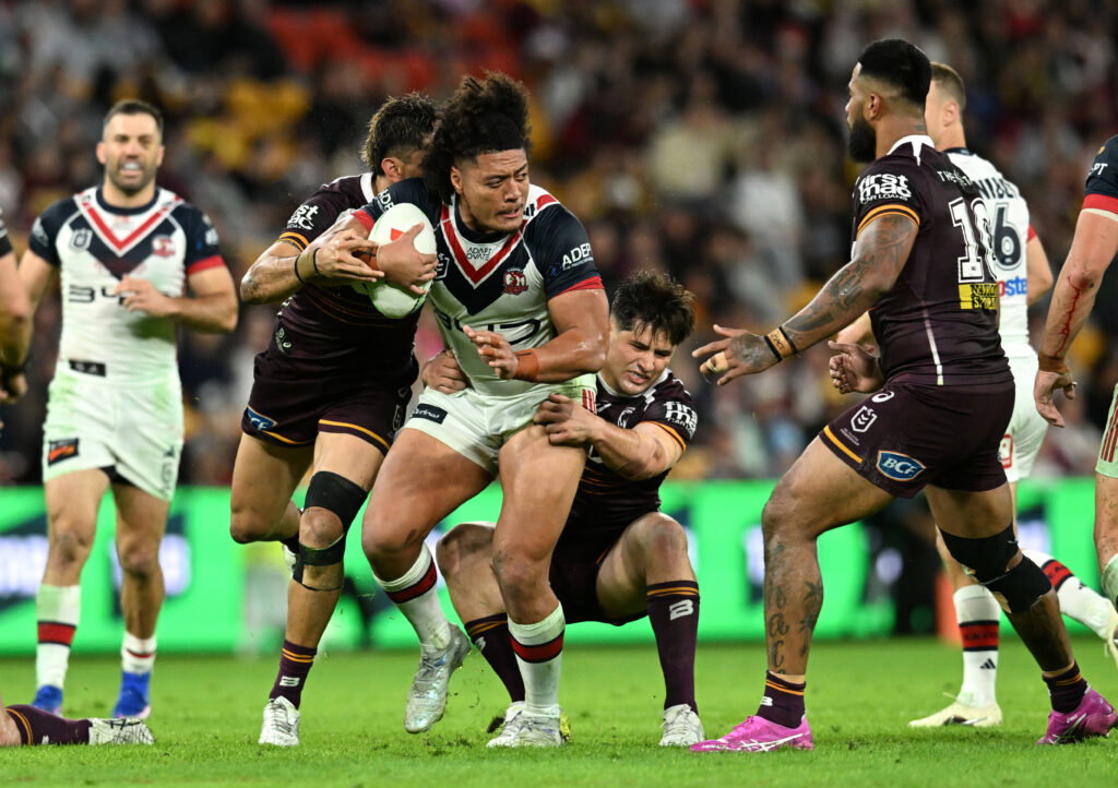 Match action between the Broncos and Roosters.