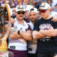 Billy Walters with Brisbane Broncos teammates Cory Paix and Adam Reynolds after winning the 2025 NRL Premiership.